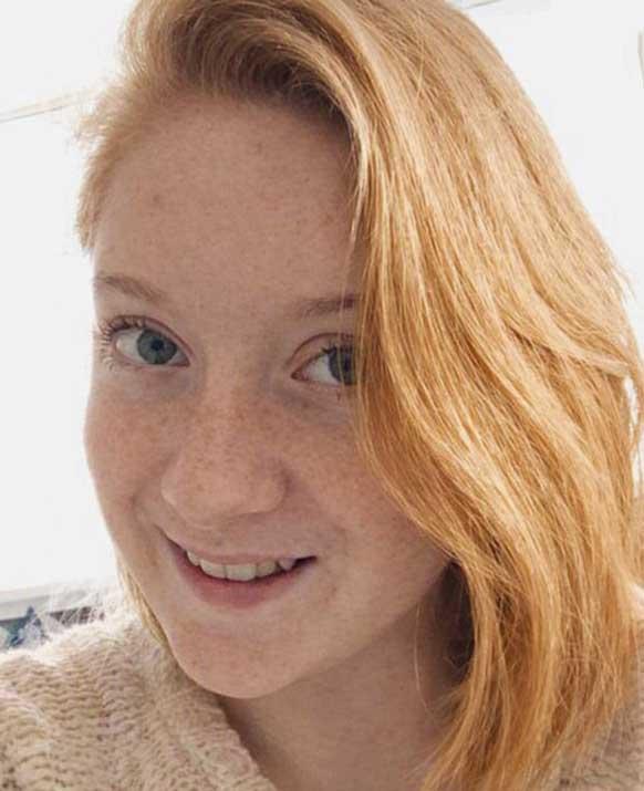 A colour portrait of Bethany Silverthorne, a woman with light skin and strawberry‑blonde hair swept to one side, wearing a cream knit sweater and looking directly at the camera with a neutral expression.